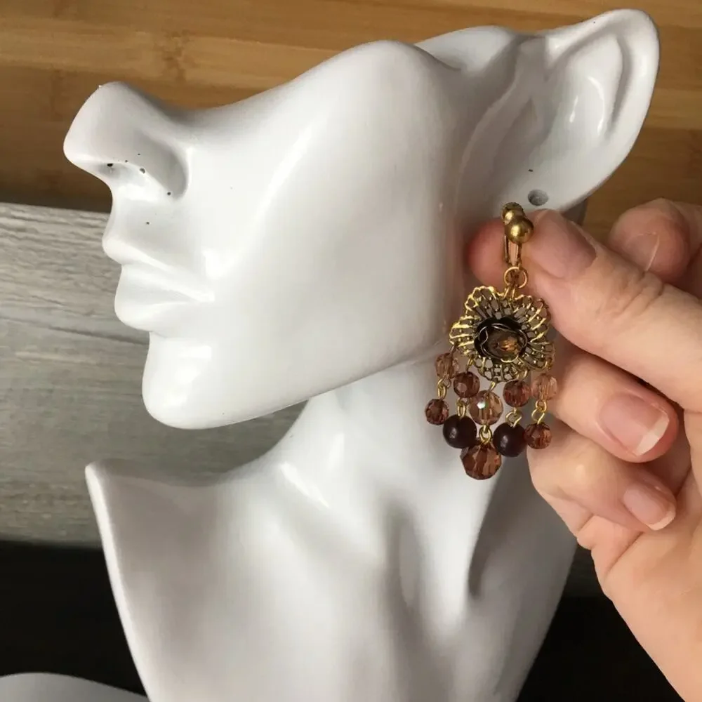 Darling ornate clip on earrings with beaded accents in amber/garnet tones